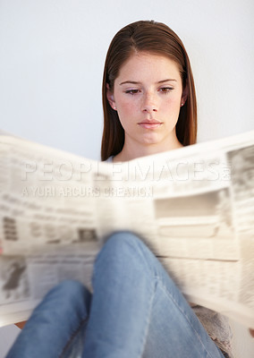 Buy stock photo Relax, living room and a woman reading the newspaper in her home on a weekend for the daily article. Wellness, press or media with a young person in her apartment to research current world events