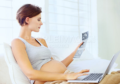 Buy stock photo Pregnant woman, laptop and ultrasound image in home with relax wellness and excited on prenatal care in bedroom. Person, love or sonogram photo with technology on bed, fetus growth or development