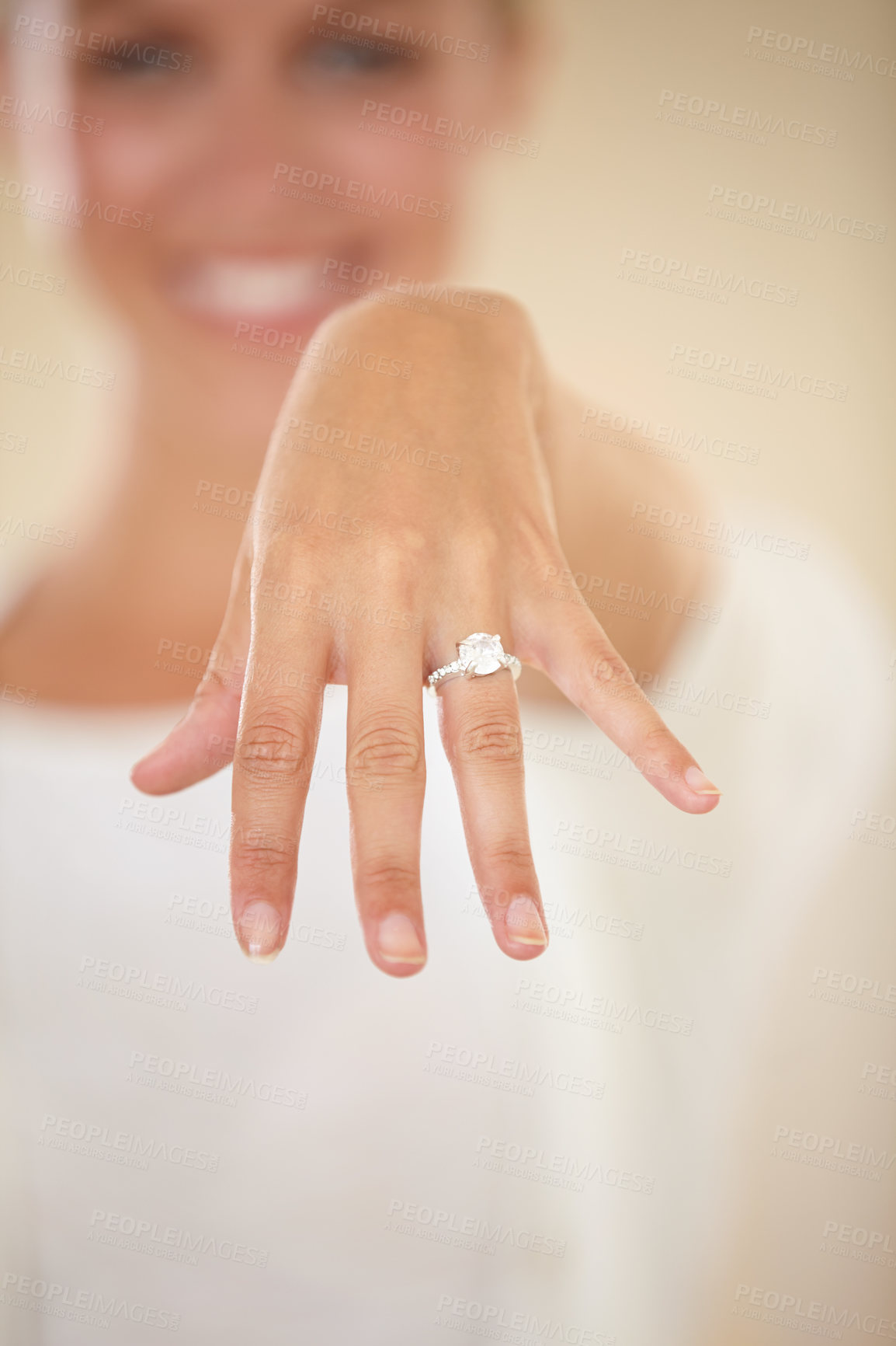 Buy stock photo Cropped shot of a young woman showing off her engagement ring