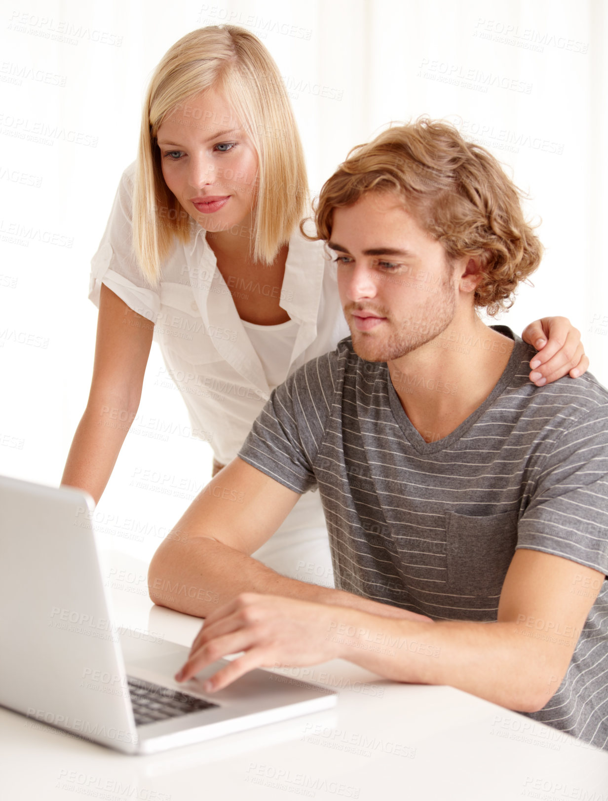 Buy stock photo A young couple using a laptop to browse the net