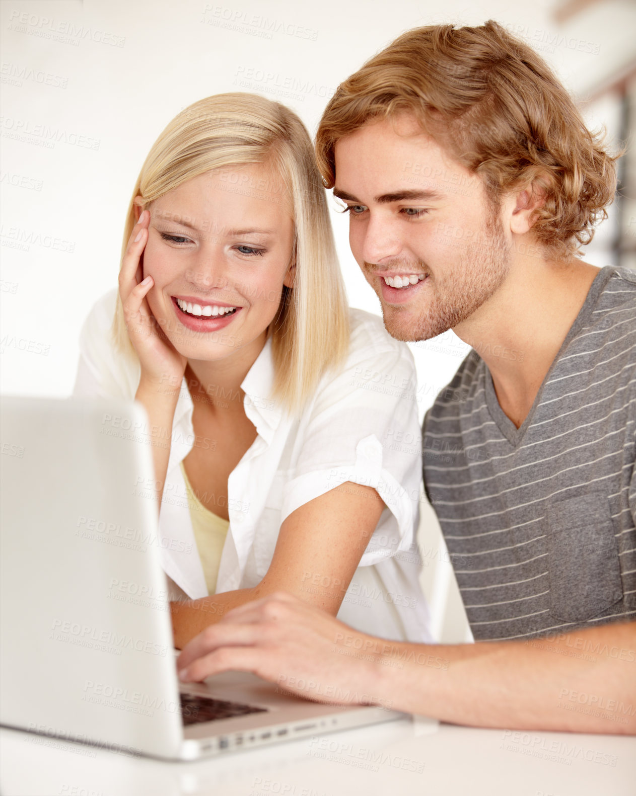 Buy stock photo A young couple using a laptop to surf the net