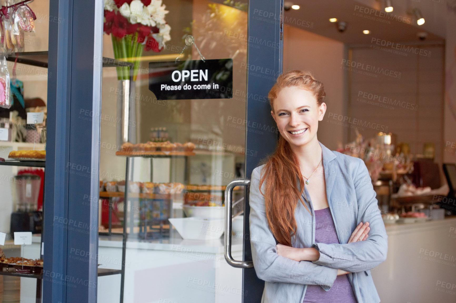 Buy stock photo Portrait of an attractive young woman standing confidently in her bakery doorway