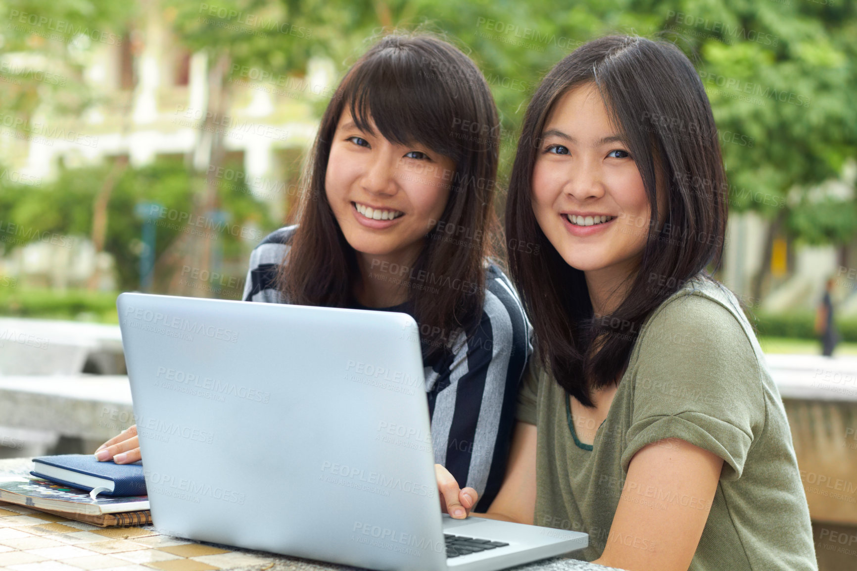 Buy stock photo Two young students sitting outside together