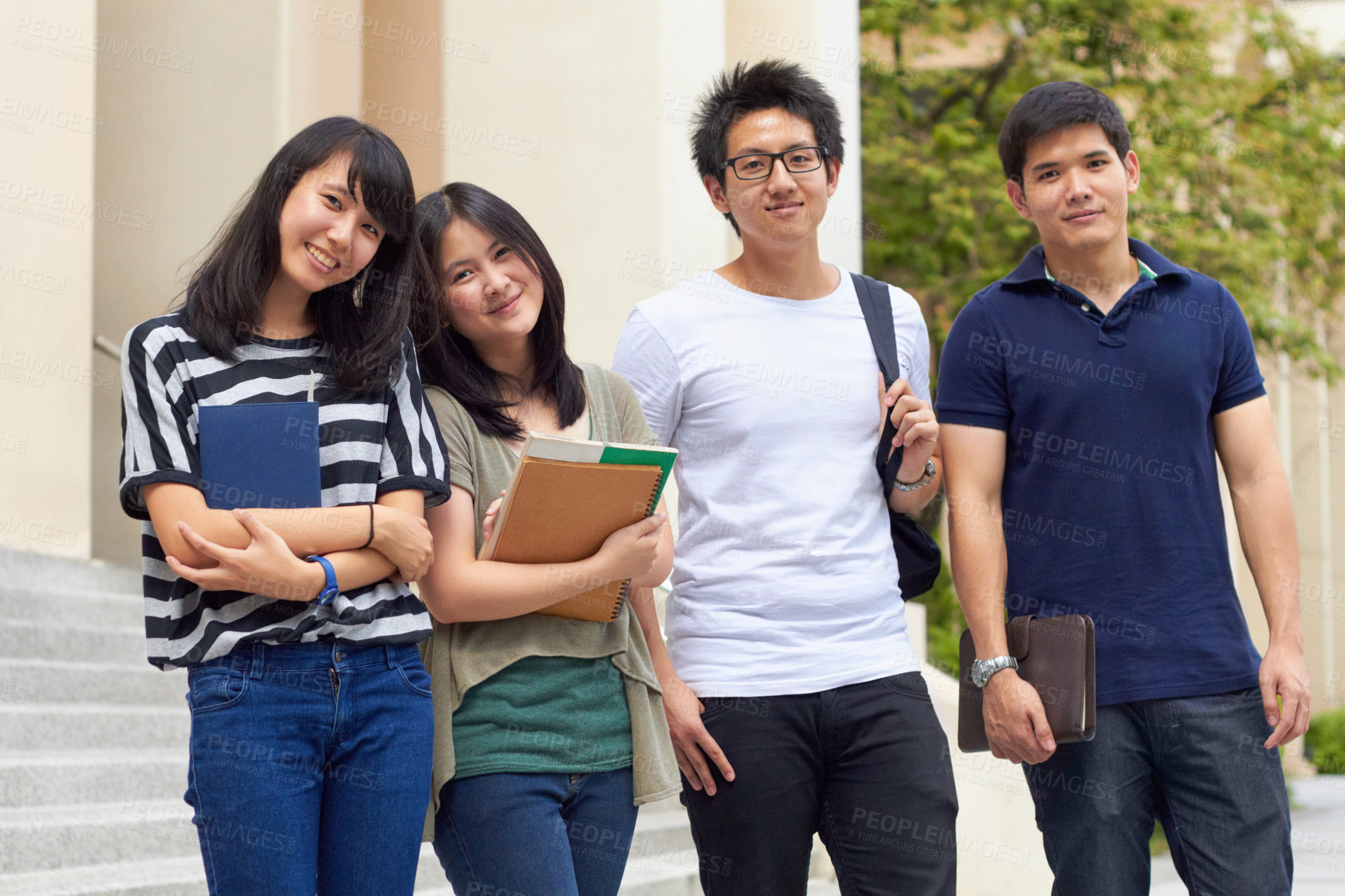 Buy stock photo Four young students leaving camous