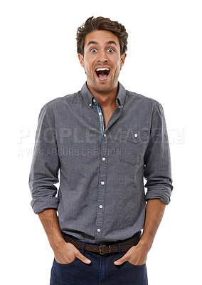 Buy stock photo Portrait of a handsome young man looking shocked with his hands in his pockets