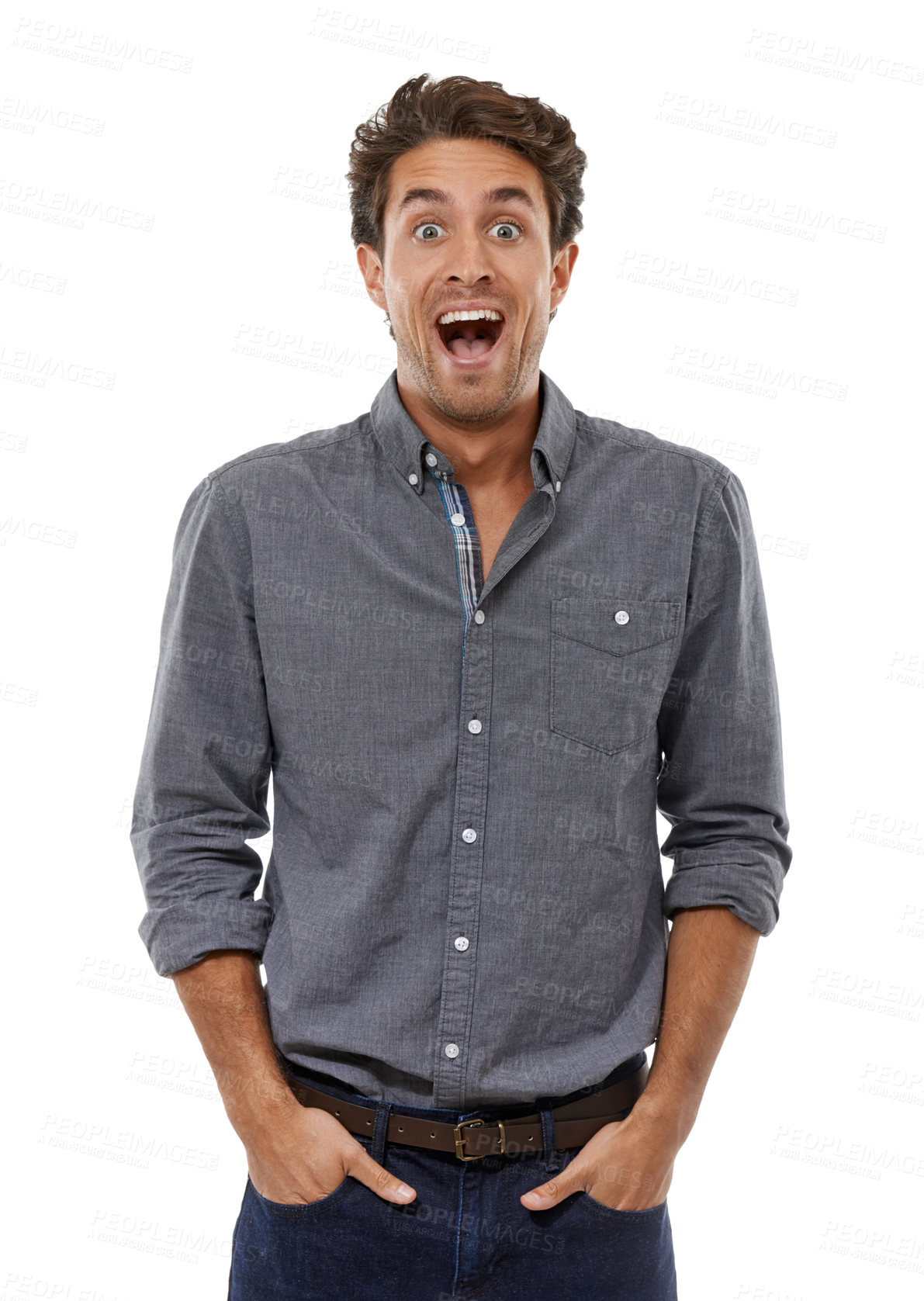 Buy stock photo Portrait of a handsome young man looking shocked with his hands in his pockets