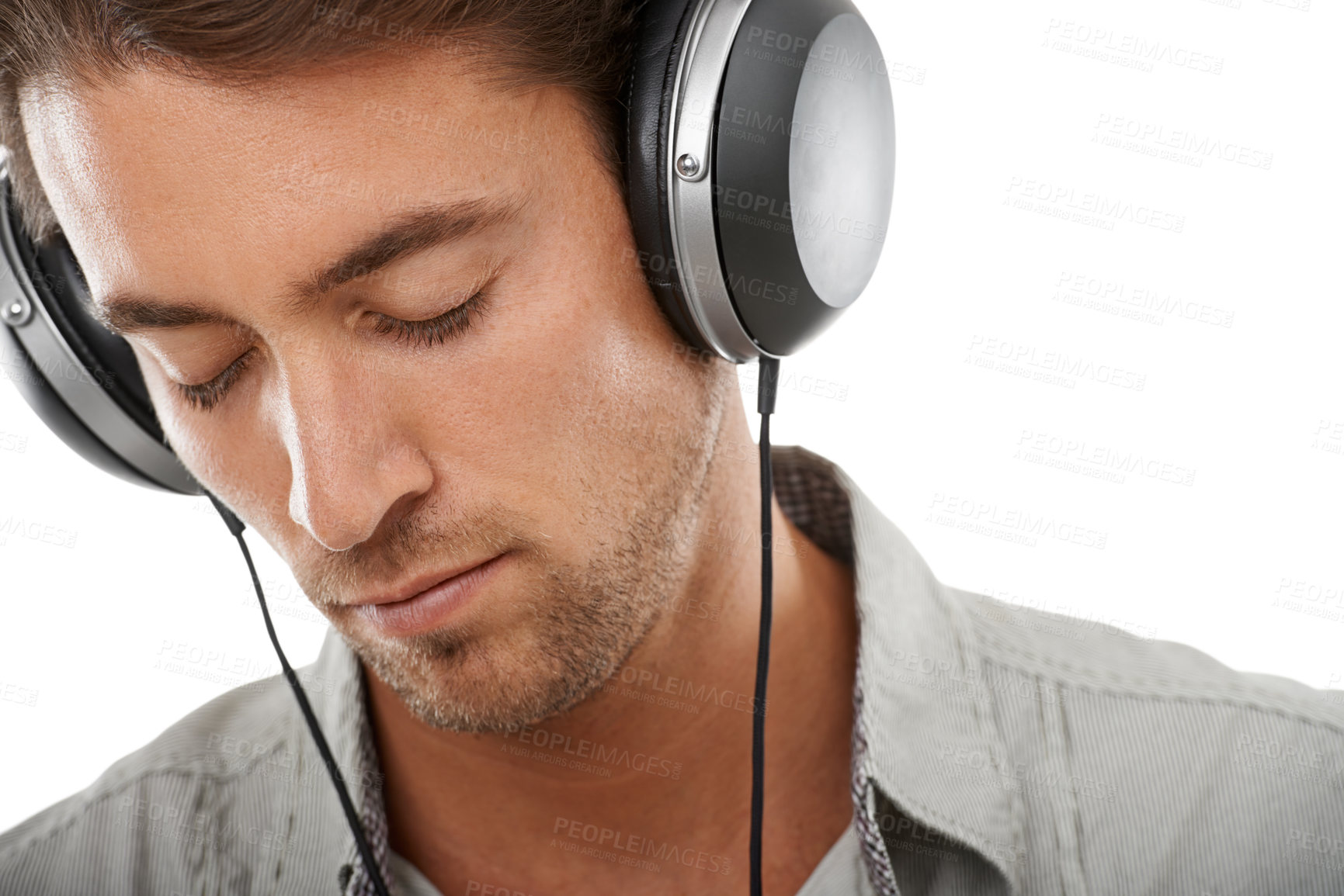 Buy stock photo Calm, man and listening to music in studio with headphones for audio subscription, streaming multimedia or radio on white background. Face, model and hearing peaceful podcast, sound or song at mockup