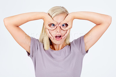 Buy stock photo Young woman, silly and fingers glasses, happiness and girl isolated on white studio background. Female, lady and creative with funny face, gesture and happy on backdrop, hands around eyes and fun