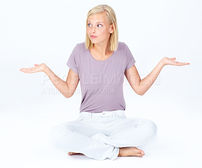 Buy stock photo Confused woman, sitting and arms out in clueless expression against a white studio background. Isolated female model posing on floor in confusion, uncertain or unknown with shrugging shoulders