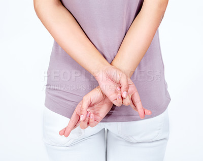 Buy stock photo Back, closeup and fingers crossed for hope, woman and waiting for blessing with girl isolated on white studio background. Zoom, young female and gesture for believe, hands and liar with good luck