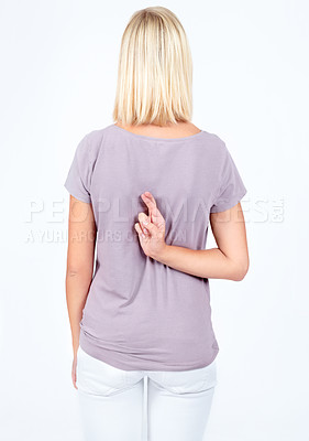 Buy stock photo Back, promise and woman lying with fingers crossed isolated on a white background in studio. Liar, good luck and girl hiding crossing fingers for a superstition or lie on a studio background