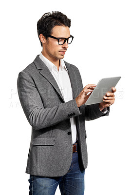 Buy stock photo A handsome young man working on his tablet