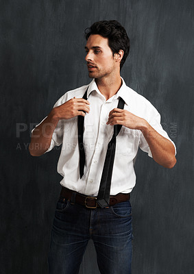 Buy stock photo Serious, fashion and young man in a studio with formal, cool trendy and elegant outfit with confidence. Pride, handsome and male model from Canada with classy style posing isolated by gray background
