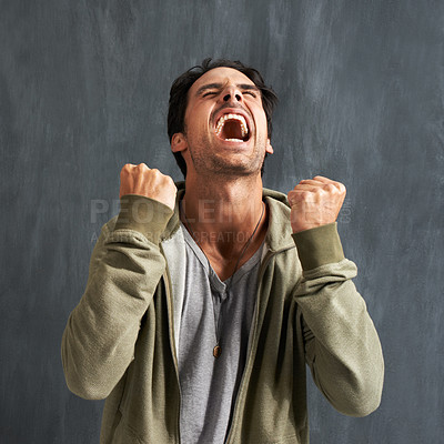 Buy stock photo A young man yelling in frustration with his eyes closed