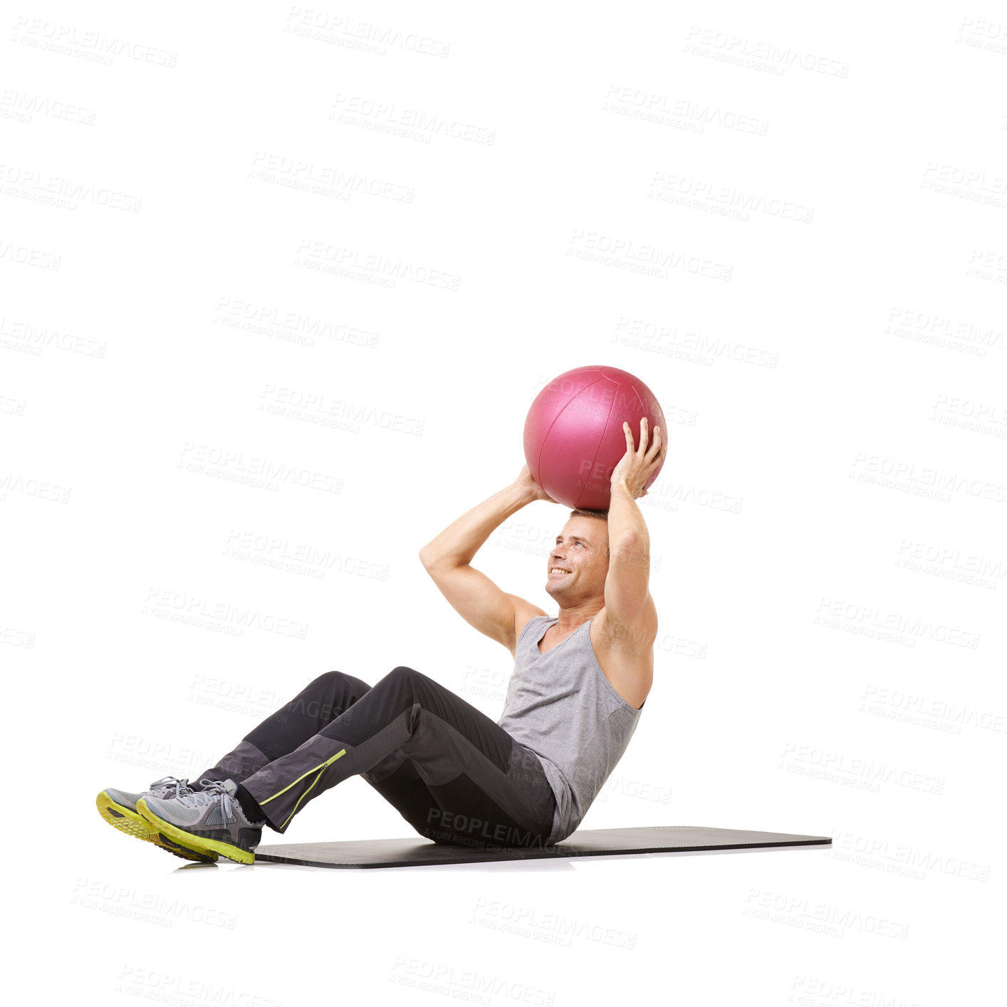 Buy stock photo A young man working out with a medicine ball on a white background