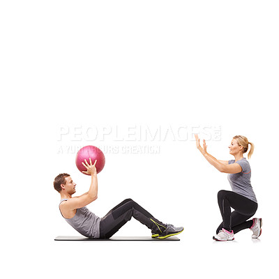 Buy stock photo Training, man and woman with gym ball for fitness in studio, body wellness and support. Sports workout space, girl and personal trainer with sphere for balance, coaching and power on white background