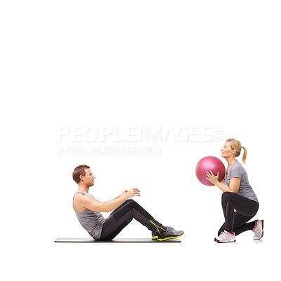 Buy stock photo Coaching, man and woman with gym ball for pilates in studio, body fitness and support. Sports workout, fit girl and personal trainer with sphere for balance, training and power on white background.