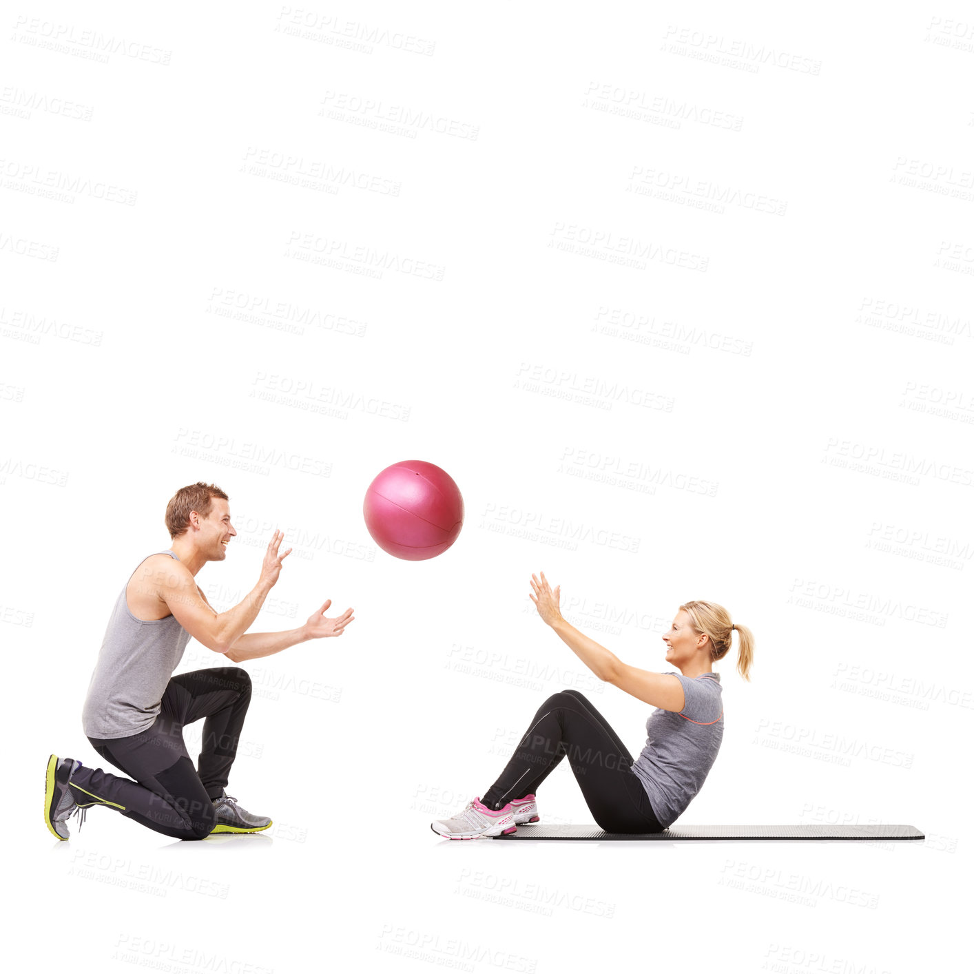 Buy stock photo A man and woman exercising their abs by passing a medicine ball to each other
