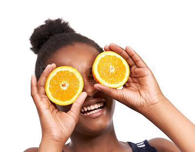 Buy stock photo Studio portrait of a happy young african american girl holding  orange halves in front of her eyes isolated on white