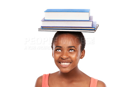 Buy stock photo Studio shot of a young african girl balancing books on her head isolated on white
