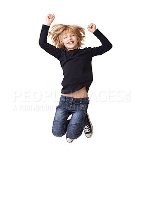 Buy stock photo Portrait of a pretty little girl smiling and jumping with arms raised in the air against a white background