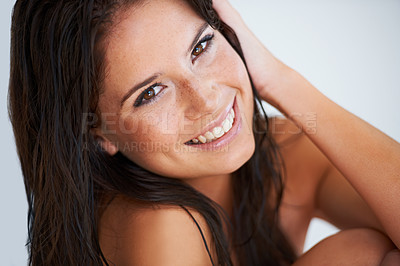 Buy stock photo Closeup portrait of a young women with wet hair smiling at the camera