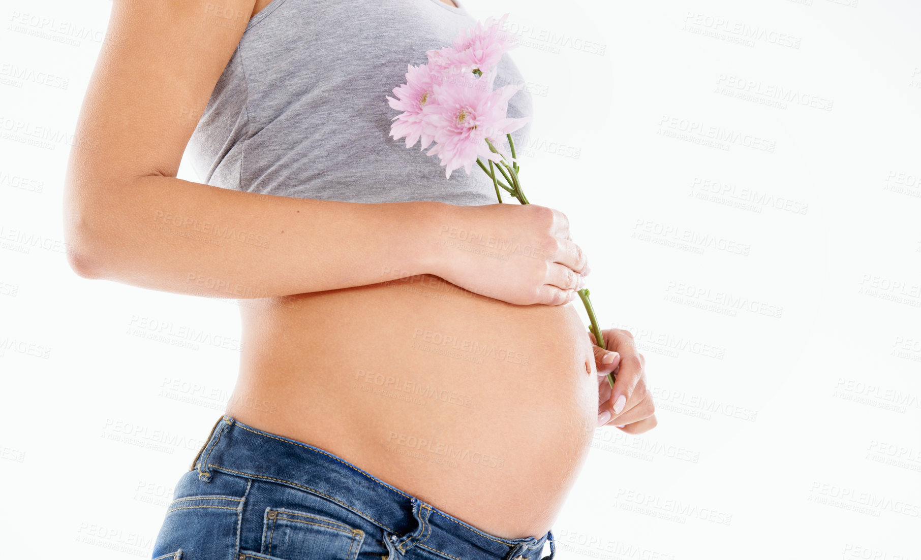 Buy stock photo Flower, pregnant and woman in studio for health, wellness and gentle skincare on white background. Daisy, plant and pregnant woman hand on belly for care, beauty and product in nature on mockup