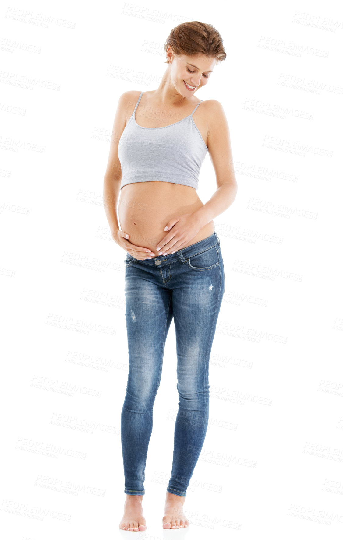 Buy stock photo Body of a pregnant woman in studio on a white background happy with pregnancy health, growth and development. Healthcare, wellness and an excited mother, hand holding stomach with advertising mockup