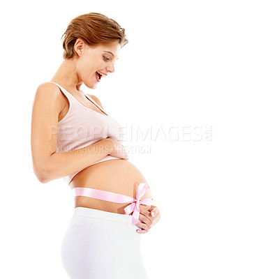 Buy stock photo Pregnant, woman and ribbon around stomach in studio happy, smile and excited for motherhood. Pregnancy, bow and girl touching her belly, cheerful for fertility, wellness and white background mockup