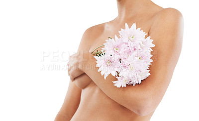 Buy stock photo Flowers, body and beauty with a woman in studio covering her breasts on a white background for cancer awareness. Wellness, nude and luxury with a female posing to promote natural breast health