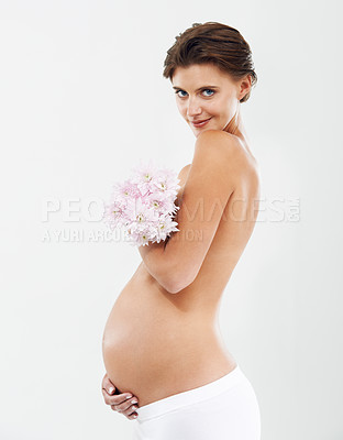 Buy stock photo Pregnancy, photo shoot and portrait of a woman with flowers on a white background in studio. Smile, stomach and pregnant woman with a bouquet of Deutzia for love of a child on a studio background