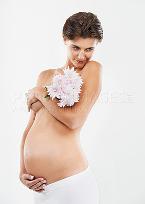Buy stock photo Pregnancy, abdomen and woman with flowers for motherhood on a white background in studio. Smile, stomach and pregnant woman with a bouquet of Deutzia for love of a child on a studio background