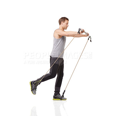 Buy stock photo Exercise, workout and resistance band with a young man in studio isolated on a white background for health. Gym, fitness or performance and a strong athlete training with equipment for wellness