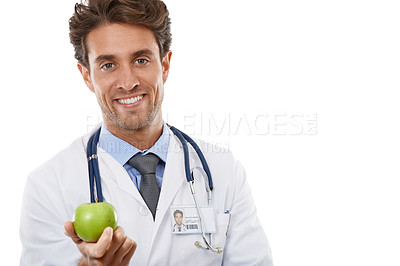 Buy stock photo Portrait, smile and apple with a man doctor in studio isolated on a white background for diet or nutrition. Food, healthcare or medical and a happy young medicine professional with a green fruit