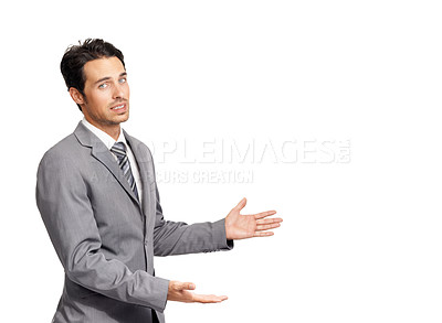 Buy stock photo A nervous young businessman gesturing towards copyspace while isolated on a white background