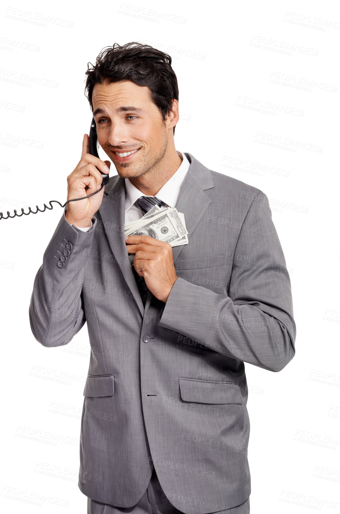 Buy stock photo An unethical businessman shoving a wad of cash into his jacket pocket while on a telephone