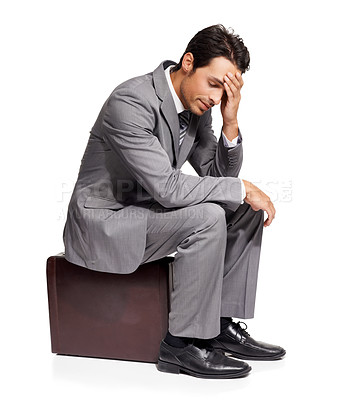 Buy stock photo Thinking, stress and business man with briefcase in studio for travel, fail or mistake on white background. Doubt, anxiety and person sitting on a bag with headache, disaster or compliance problem