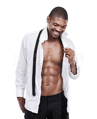 Buy stock photo A handsome young man standing wth his shirt open in the studio