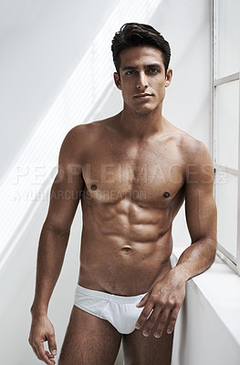 Buy stock photo Cropped shot of a handsome young man posing in his underwear