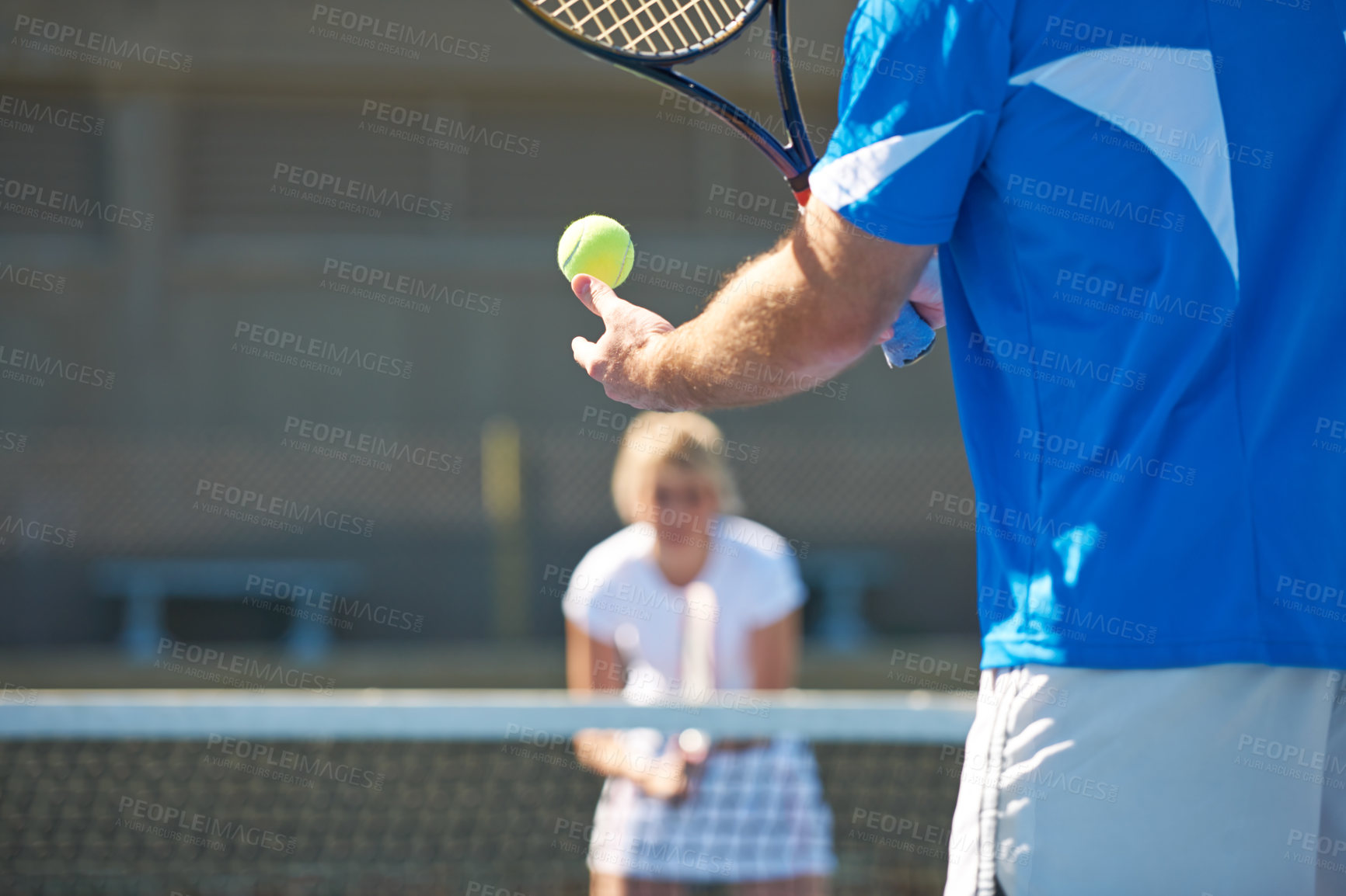 Buy stock photo Cropped image of a man bouncing a tennis ball in his hand before a service