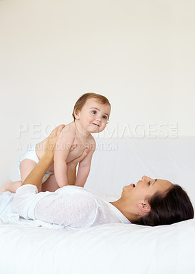 Buy stock photo Happy, baby and mother playing on bed, love and affection or bonding with toddler, smile and connection. Mom, kid and child development at home, care and support or security, motherhood and bedroom