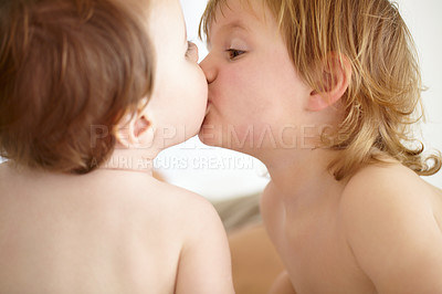 Buy stock photo Family, love and baby siblings kissing closeup in their home for love, growth or child development. Kids, together or bonding with an infant child and his brother in a bedroom of their apartment