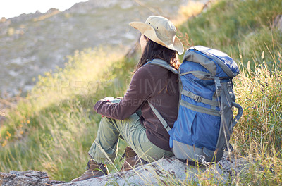 Buy stock photo A young hiker with her backpack looking out at the scenery