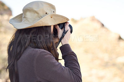 Buy stock photo A young woman taking pictures outside