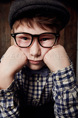 Buy stock photo Portrait, glasses and bored kid, sad expression and thinking of depression. Tired face, nerd and young boy child in hat, geek in eyewear or exhausted with learning, serious or stress in New Zealand