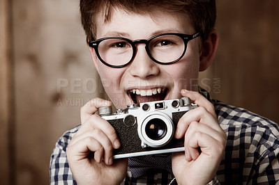 Buy stock photo Mockup, portrait and boy with vintage camera with happiness and edgy fashion in glasses by backdrop. Child, face and nerd with retro photography equipment and eyewear for creative kids with vision
