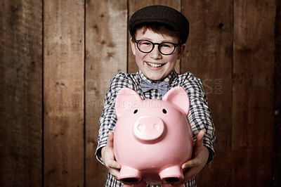 Buy stock photo Child, piggy bank or excited in portrait by studio background, savings or finance lesson in youth. Boy, smile and face in coin banking of small change and cash learning in vintage fashion in mockup