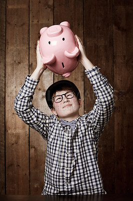 Buy stock photo Young boy in retro clothing shaking his piggybank