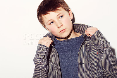 Buy stock photo Young adolescent boy adjusting his shirt against a white background