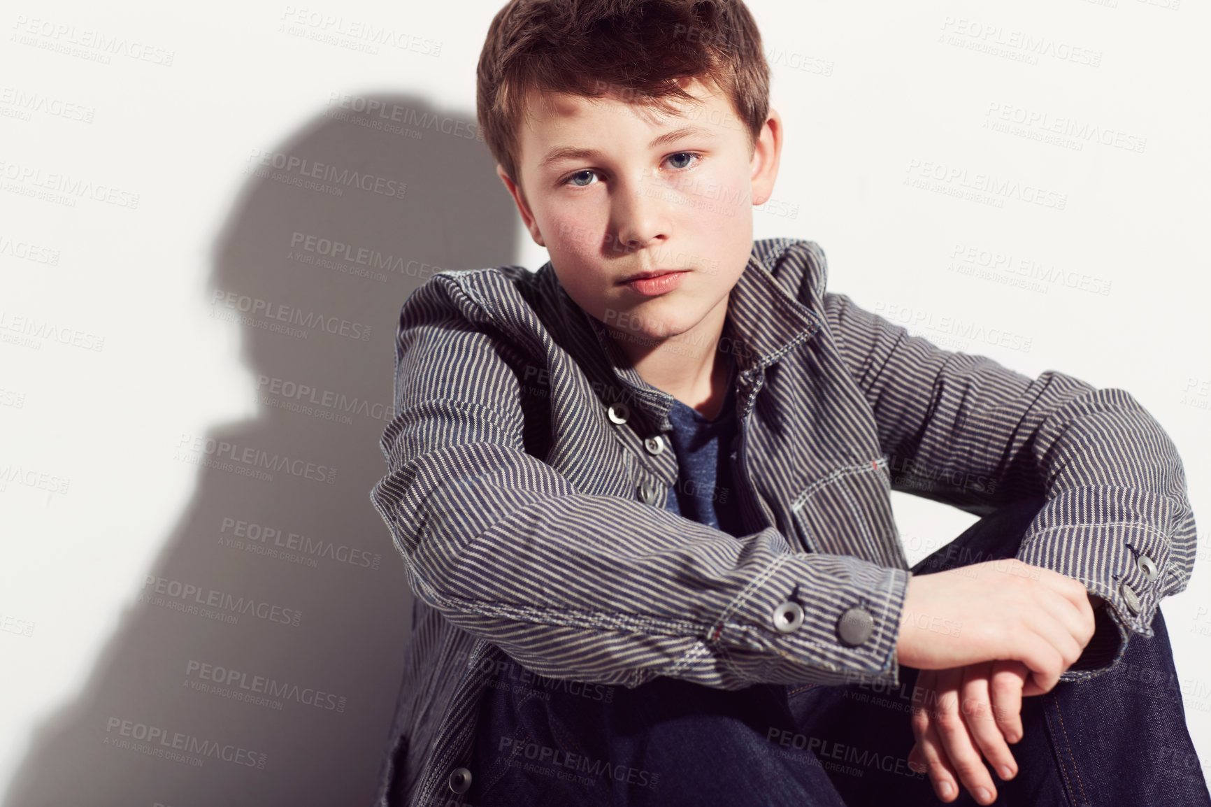 Buy stock photo Serious, boy and portrait of teenager with fashion in studio, white background or mockup. Child, sitting and relax in cool style and clothes with confidence, pride and hipster personality in space